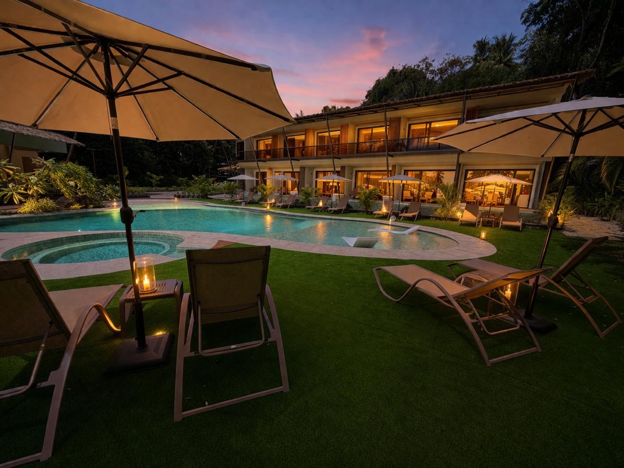 Miamar resort pool with blue shade umbrellas at golden hour