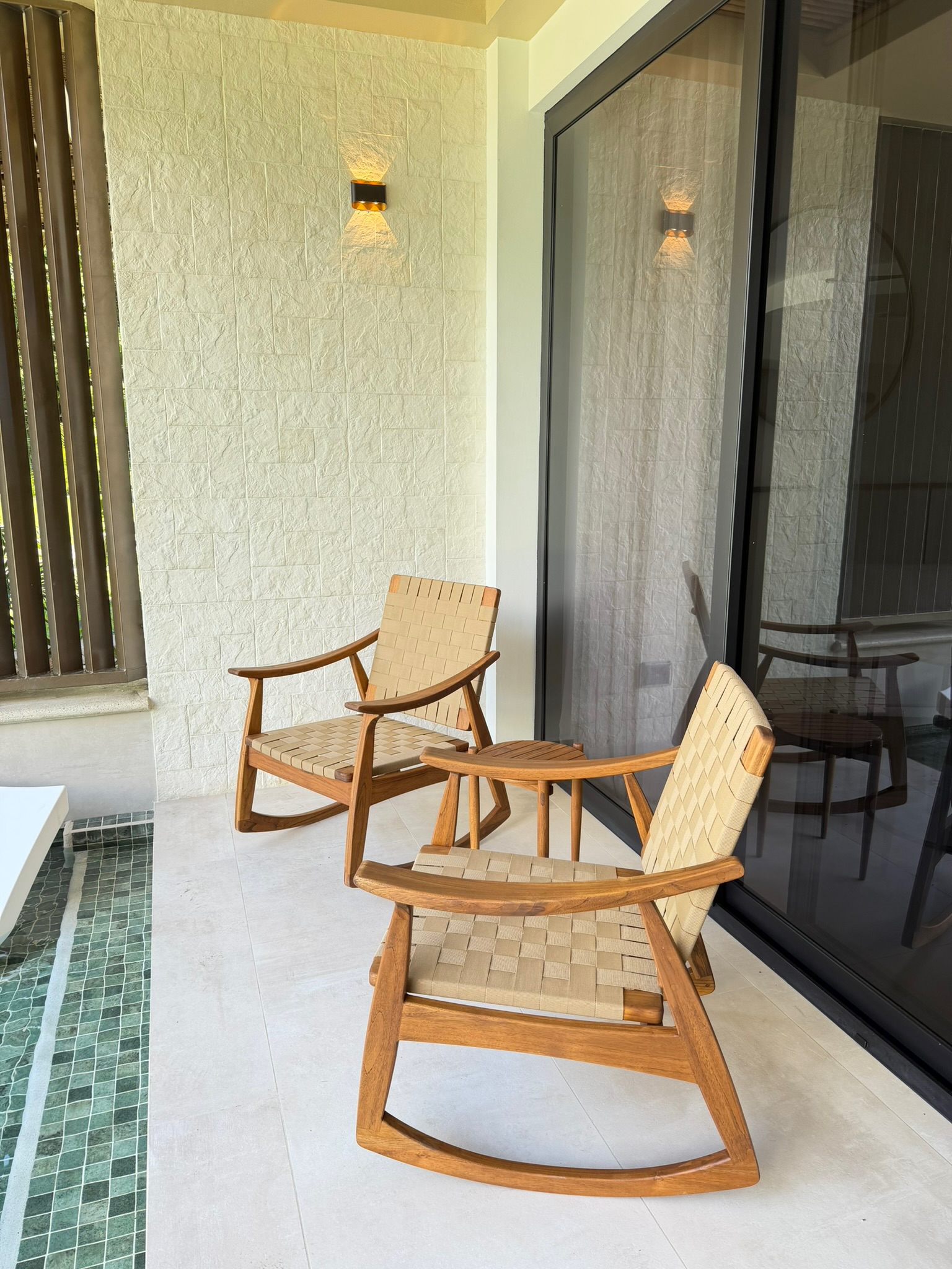 Minimalist suite balcony with wooden chairs overlooking gardens Miamar