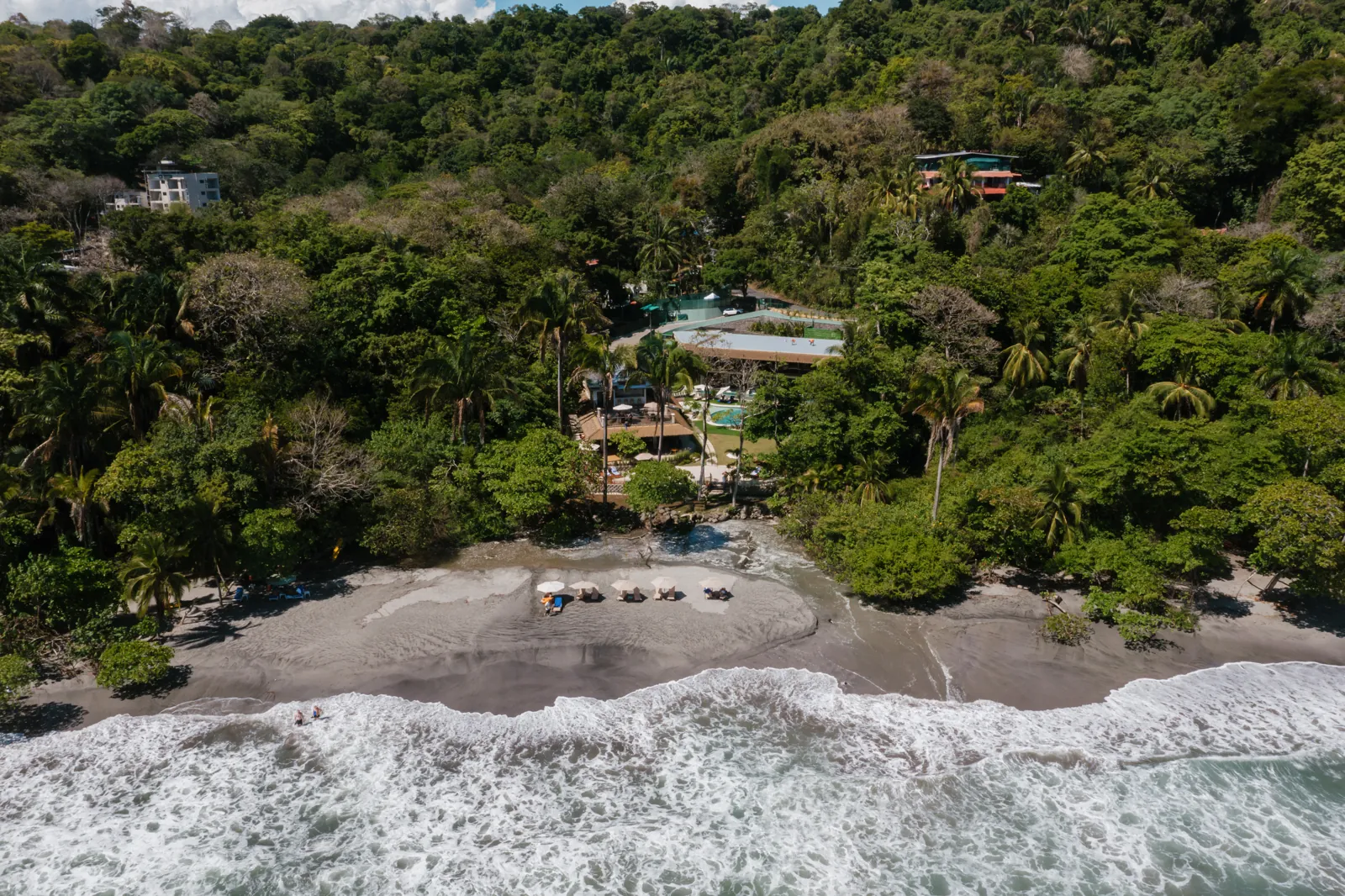 Aerial view of Miamar between the rainforest and the surf of Playa Espadilla