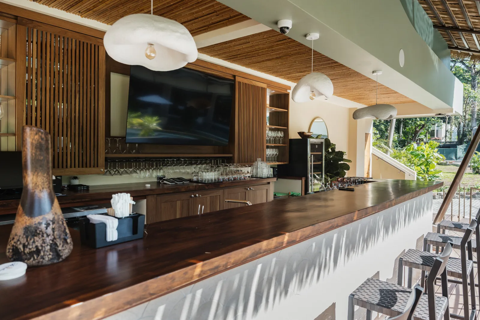 The wooden counter of Oshun Bar, open to the garden