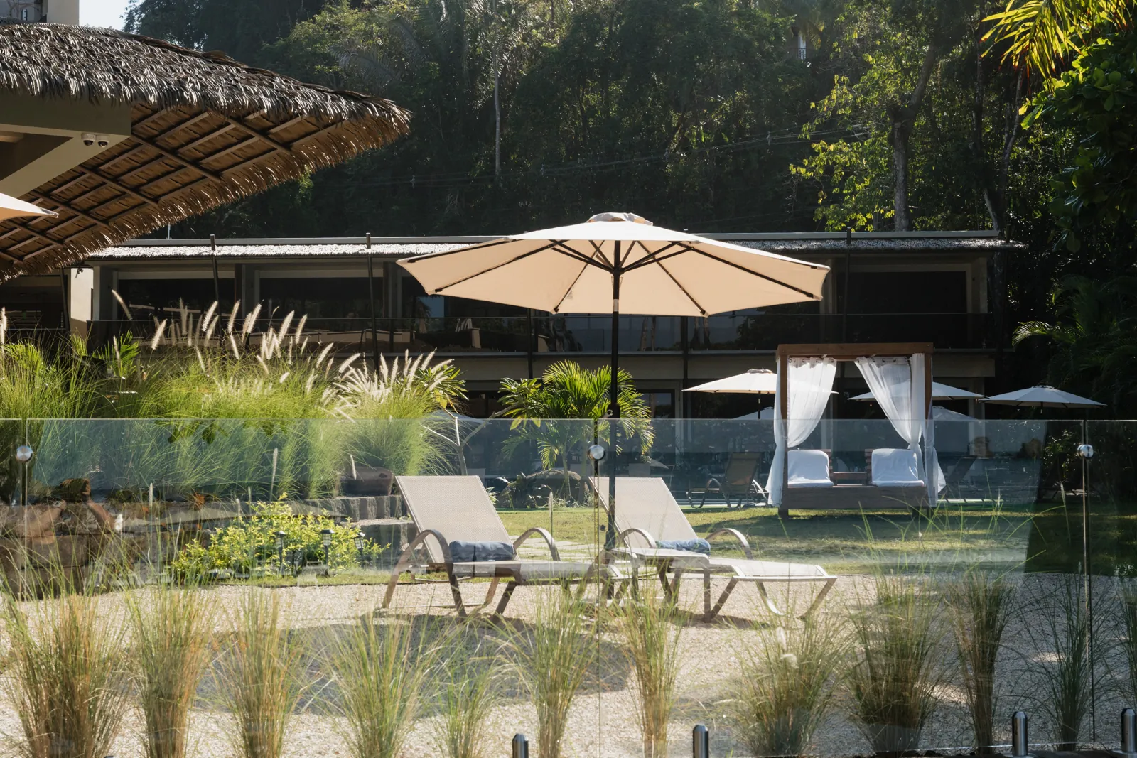 Loungers and a canopy daybed in Miamar's pool garden