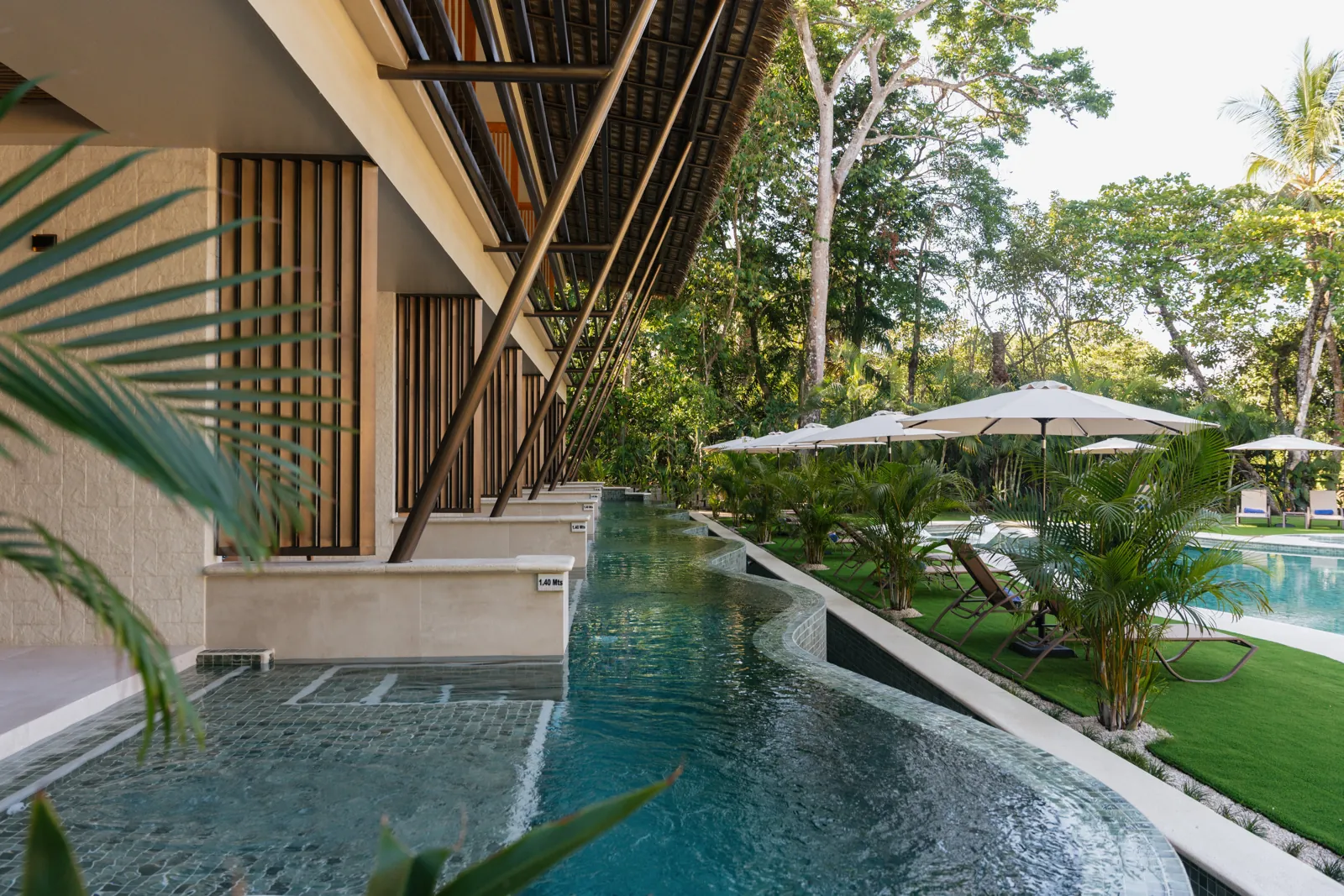 The water channel running along the ground-floor suites toward the garden pool