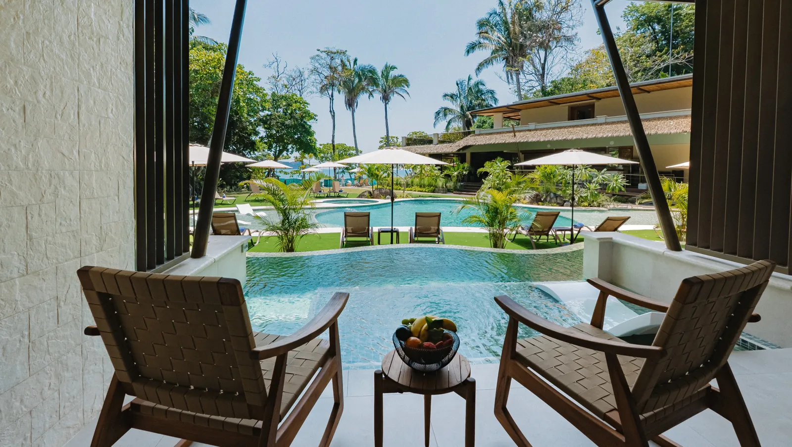 Two wooden rocking chairs on a suite terrace above the plunge pool